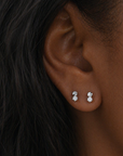 Silver Micro Duo CZ stud earrings featuring a faceted disc top with a small clear stone drop on a clean white background, minimal everyday design
