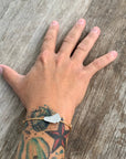 Bim Signature Silver Bracelet with 2mm cord and brushed rhodium-plated sterling silver Barbados map.