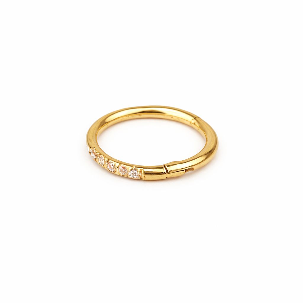 Gold ring with small diamonds on a white background