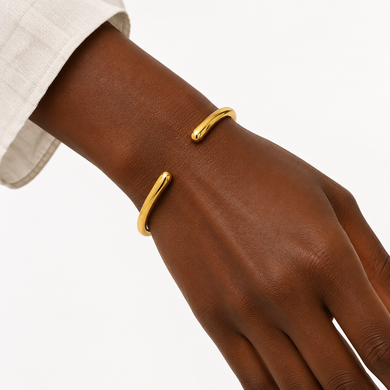 Alessia Bangle in waterproof gold featuring a sleek open bangle design with rounded ends.