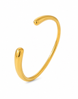 Alessia Bangle in waterproof gold featuring a sleek open bangle design with rounded ends.