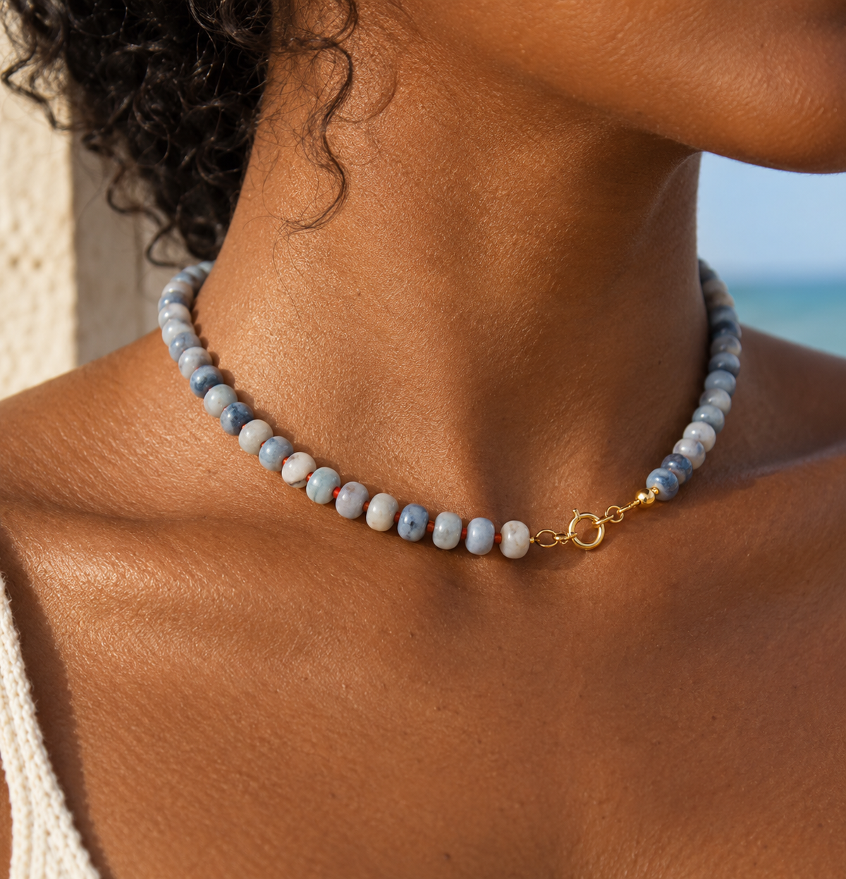 Anya Beaded Necklace with blue grey natural stone beads and 18k gold plated titanium clasp worn on model