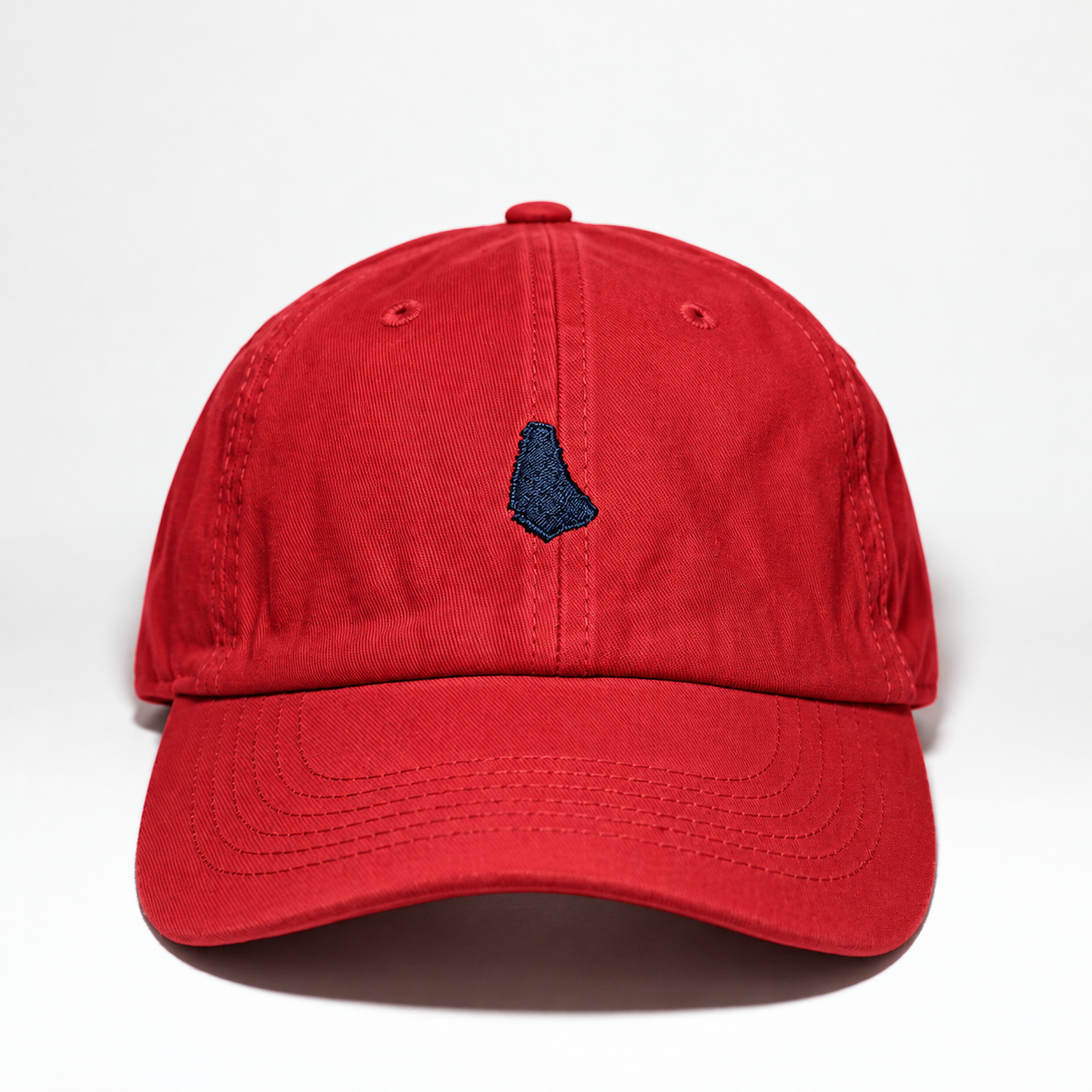 Red cotton baseball cap featuring a navy blue embroidered Barbados island silhouette on the front, with a curved brim and relaxed fit.