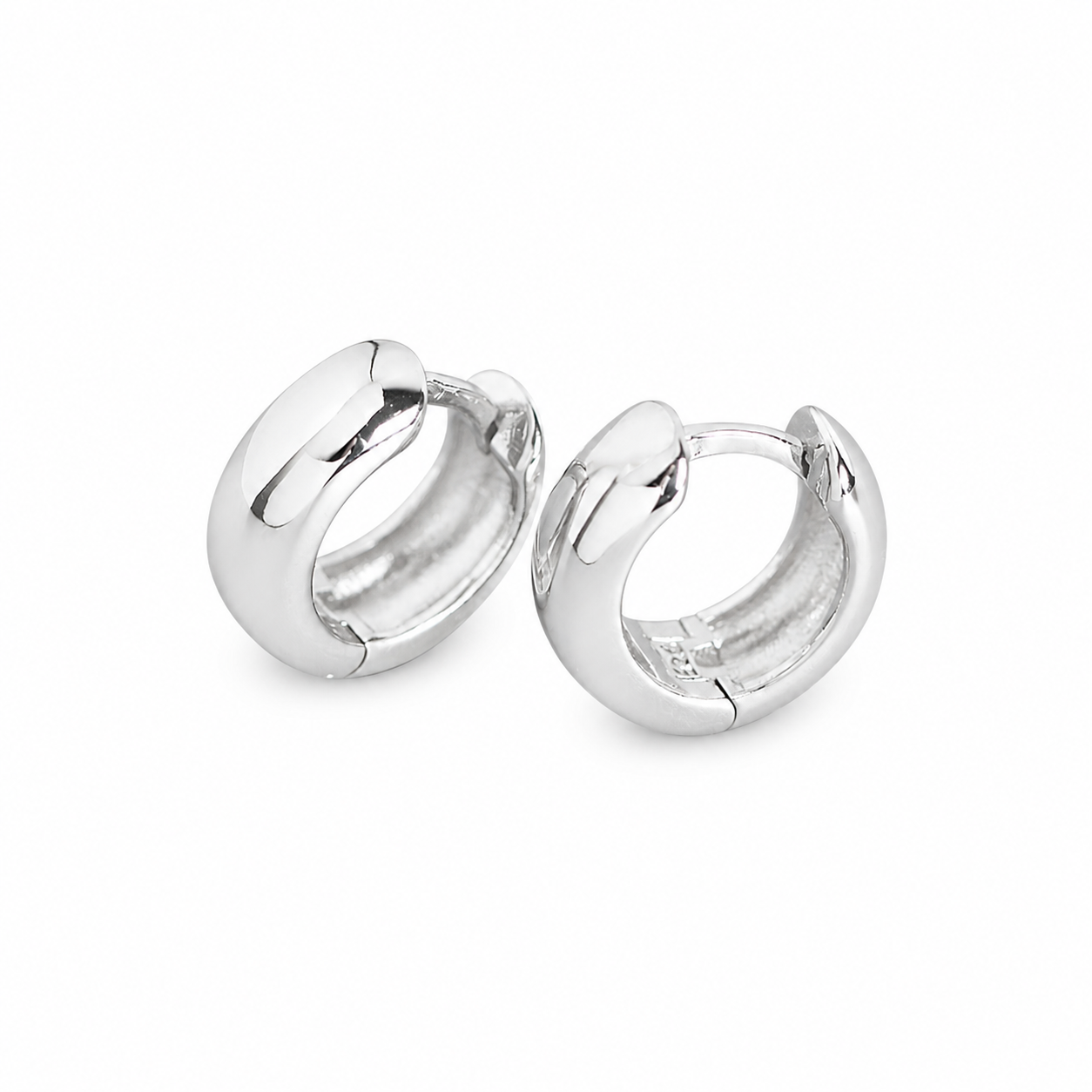 Chunky baby huggie earrings in polished silver with a smooth rounded finish, small hoop design, minimal everyday stackable earrings