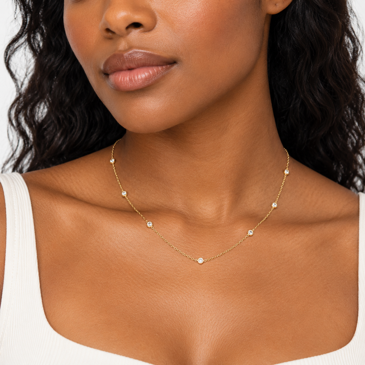 Bajan model wearing the Diamonds By The Yard Necklace in 18K gold-plated sterling silver, featuring delicate bezel-set cubic zirconia stones.