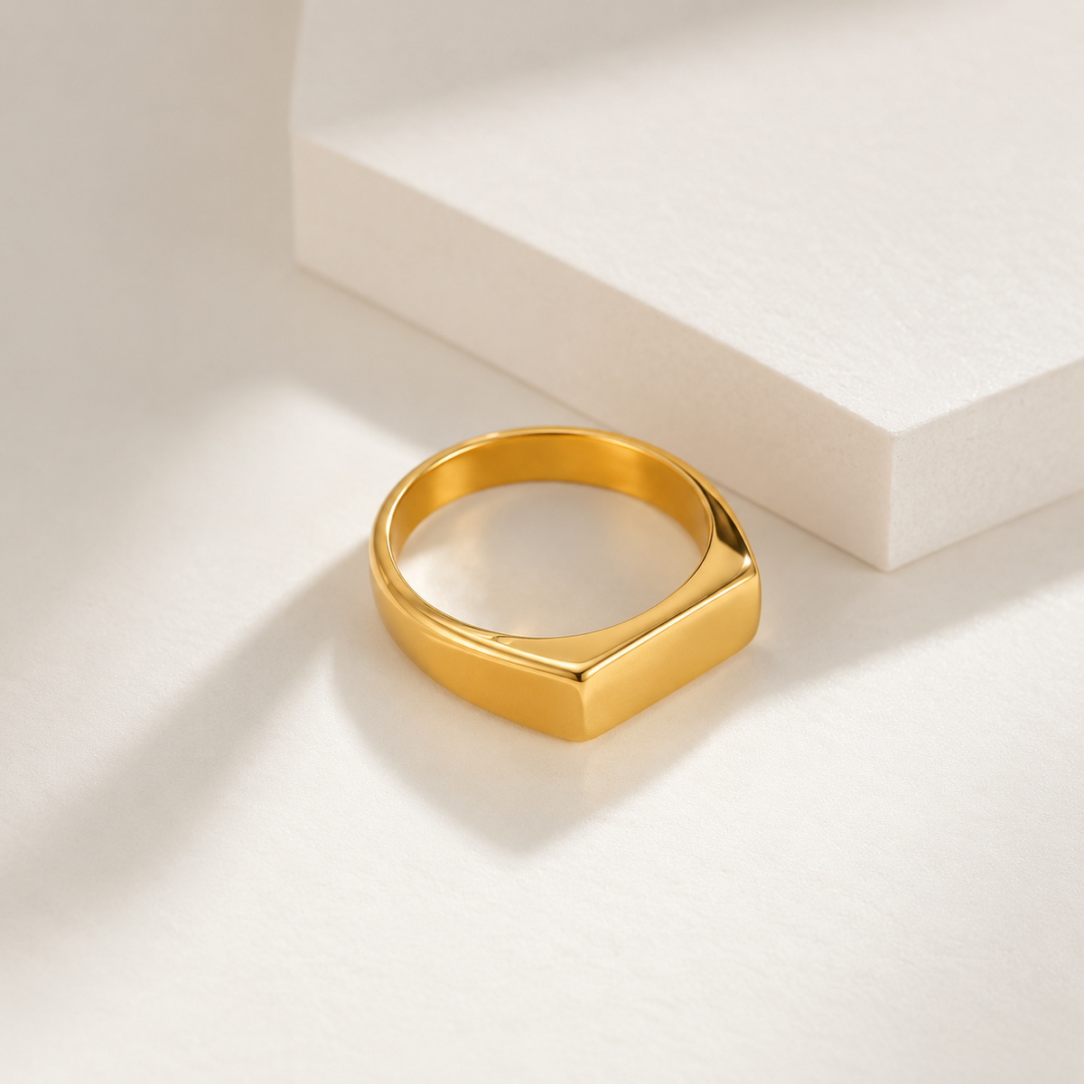 18k gold plated stainless steel signet ring with polished finish on neutral background