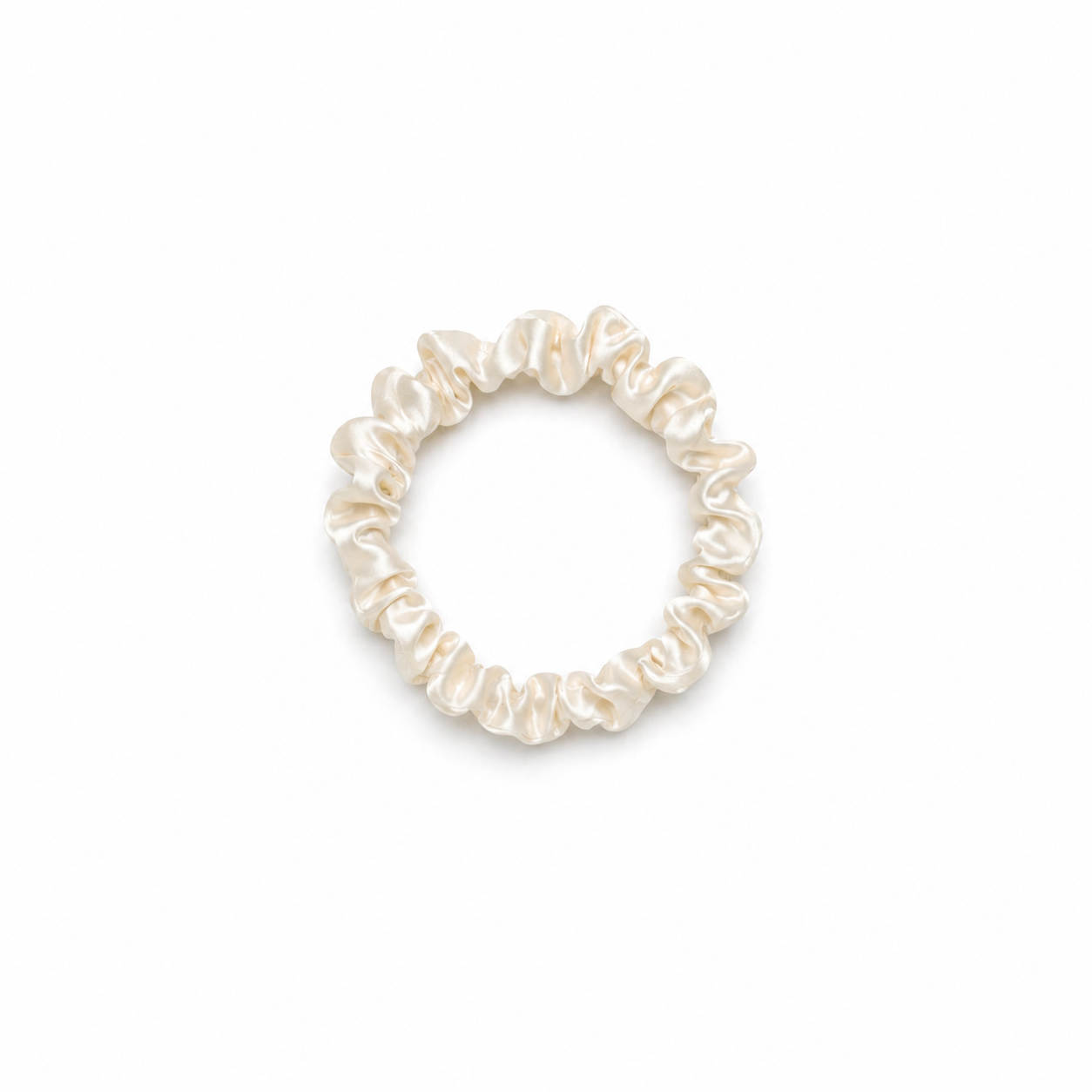 Skinny ivory satin silk scrunchy hair tie on a clean white background, minimal and lightweight design for everyday use