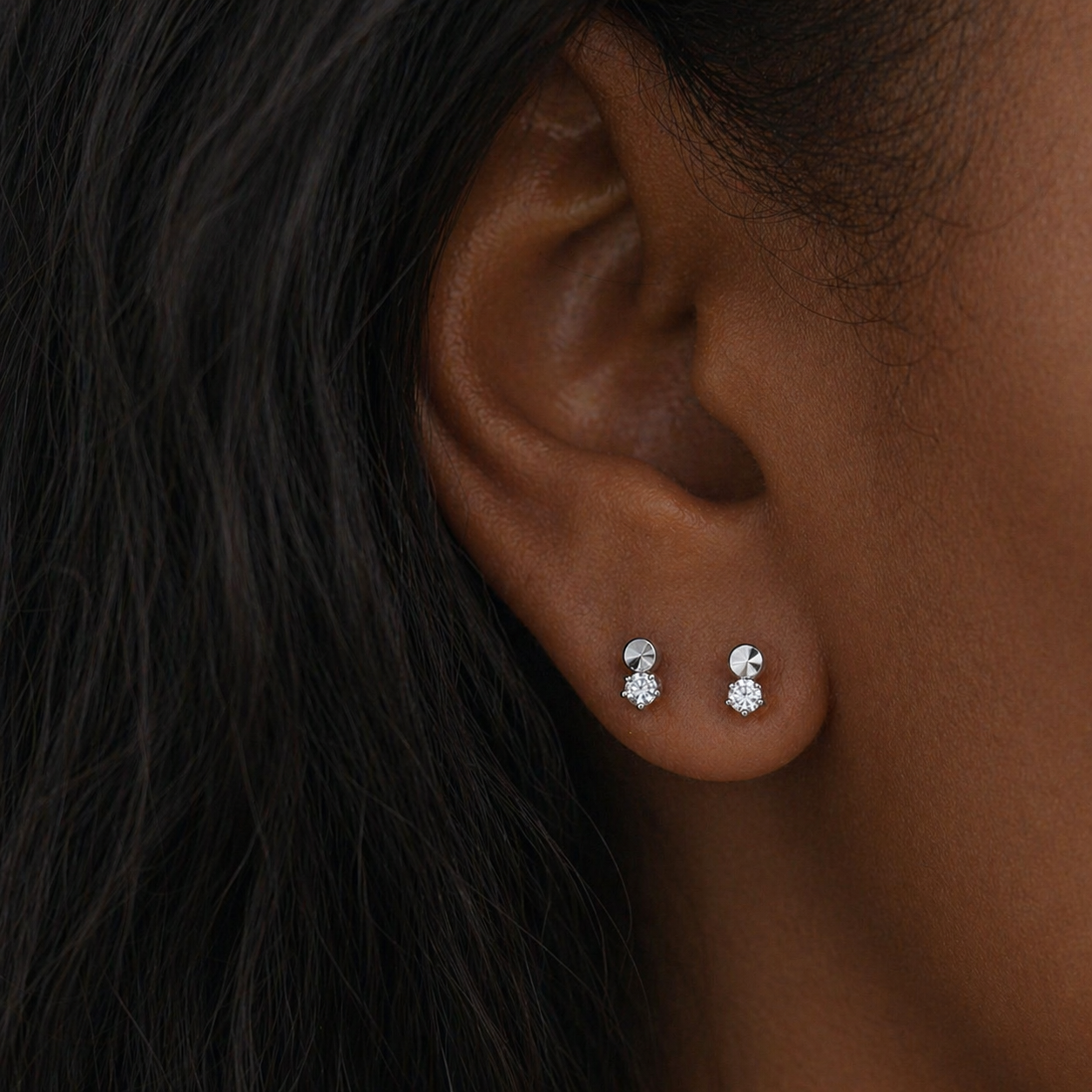 Silver Micro Duo CZ stud earrings featuring a faceted disc top with a small clear stone drop on a clean white background, minimal everyday design