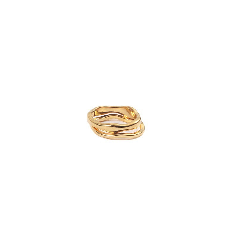 Organic wave ring in 18k gold plated stainless steel with a fluid, sculptural shape and polished finish