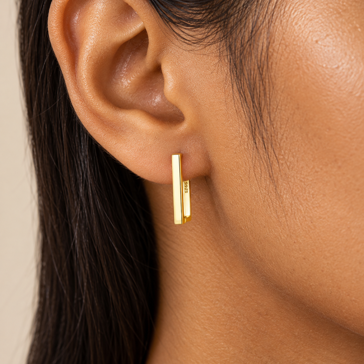 Close-up of model wearing the Quincy Square Hoops in gold-plated sterling silver, featuring a minimalist rectangular silhouette.