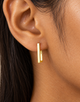 Close-up of model wearing the Quincy Square Hoops in gold-plated sterling silver, featuring a minimalist rectangular silhouette.