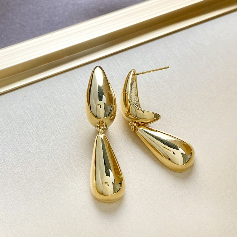 Gold sculpted tear drop earrings with double drop design and high polish finish, modern statement earrings