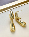 Gold sculpted tear drop earrings with double drop design and high polish finish, modern statement earrings