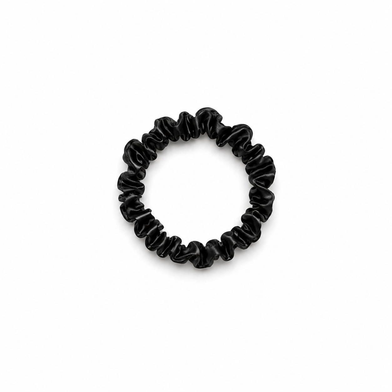Skinny black satin scrunchy hair tie on a clean white background, minimal and lightweight design for everyday use