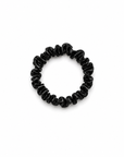 Skinny black satin scrunchy hair tie on a clean white background, minimal and lightweight design for everyday use