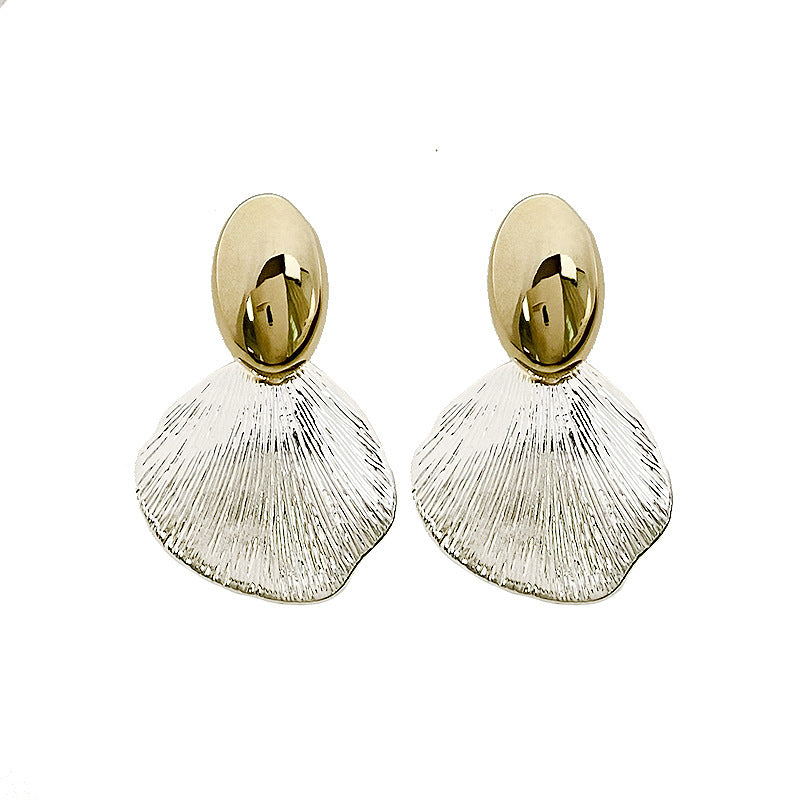 Mixed metal shell statement earrings with gold stud and textured silver drop, modern coastal design