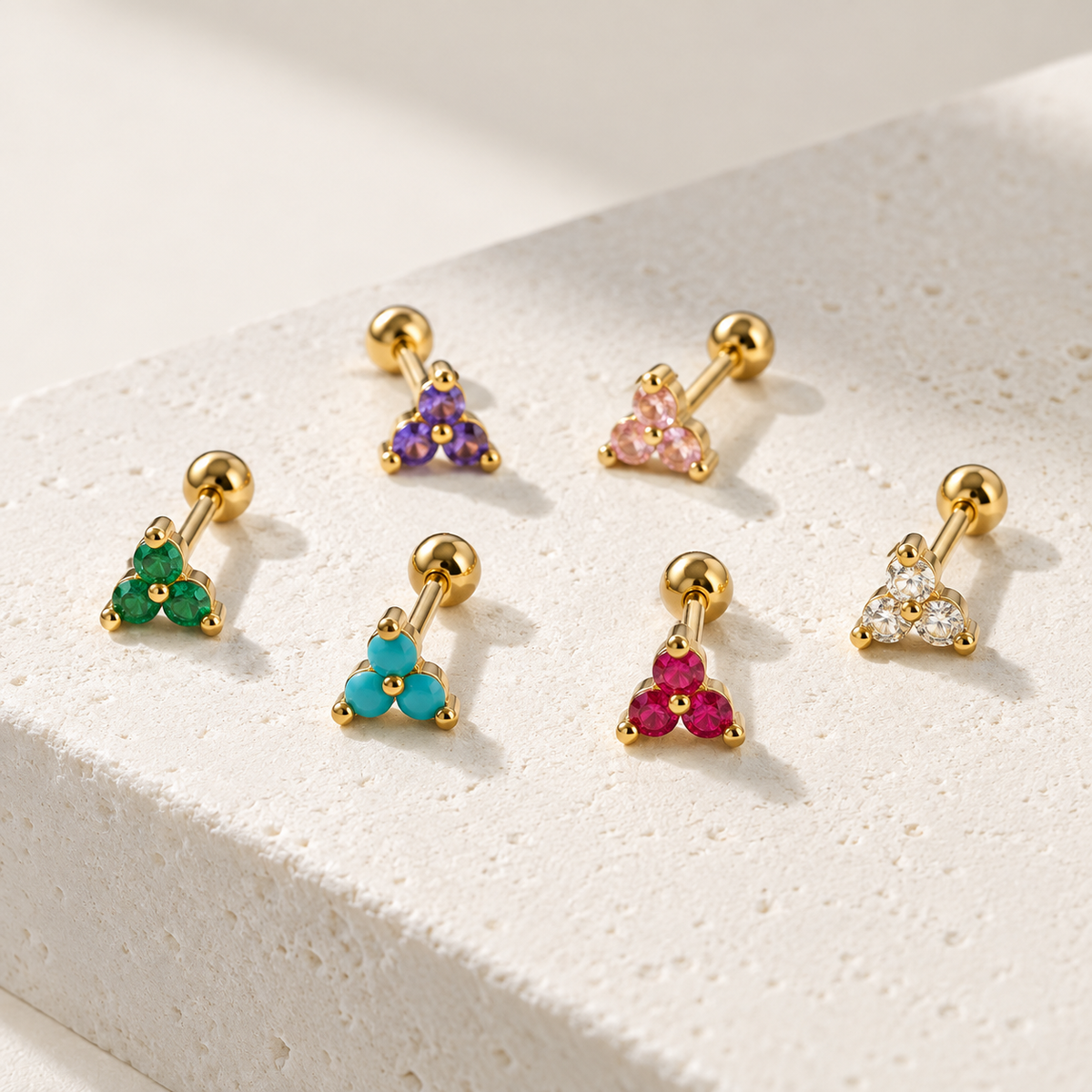 Multicolor Trinity CZ flat back studs in gold with clear, green, turquoise, pink and purple stones