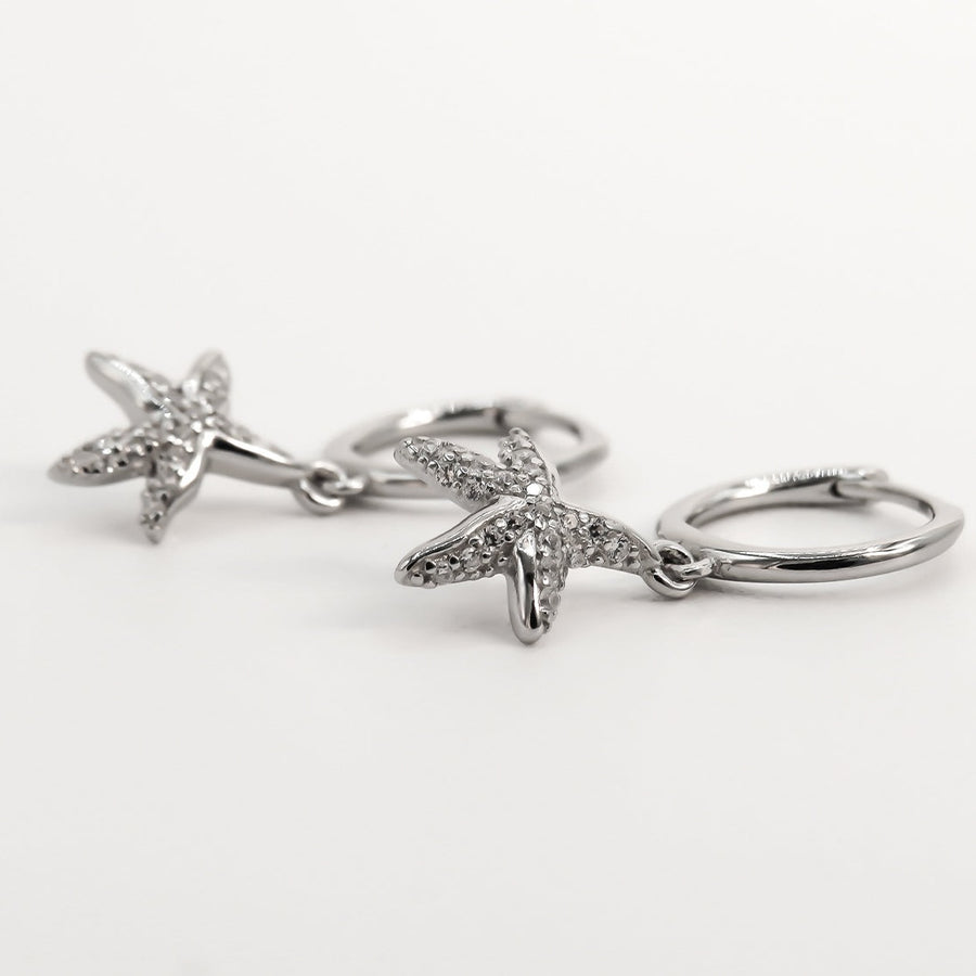 sterling silver star fish huggies with cubic zirconia 